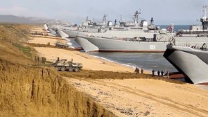 This file frame from a video released on April 23, 2021, by Russian Defense Ministry Press Service shows, Russian troops board landing vessels after drills in Crimea. Earlier this year, Russia bolstered its forces near Ukraine and warned Kyiv that it could intervene militarily if Ukrainian authorities try to retake the rebel-controlled east.