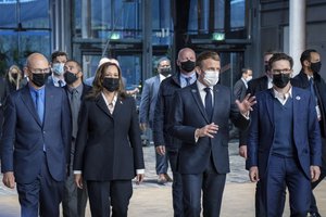 From left, former European Trade Commissioner Pascal Lamy, Vice President Kamala Harris, French President Emmanuel Macron and French historian Justin Vaïsse arrive at a Paris Peace Forum, Thursday, Nov. 11, 2021 in Paris.