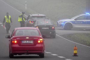 Polish military police officers check cars near the border to Belarus, that was closed because of a large group of migrants camping in the area on the Belarus side who had tried to illegally push their way into Poland and into the European Union, in Kuznica, Poland, Thursday, Nov. 11, 2021