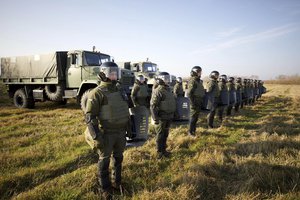 Soldiers of the Ukrainian State Border Guard Service line up at the border with Belarus in the Volyn region, Ukraine, on Thursday, Nov. 11, 2021.