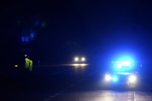 Polish police officers check cars near the border to Belarus, that was closed because of a large group of migrants camping in the area on the Belarus side who had tried to illegally push their way into Poland and into the European Union, in Kuznica, Poland, Friday, Nov. 12, 2021. (AP Photo/Matthias Schrader)