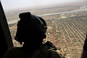 FILE - In this May 19, 2017 file photo, a French soldier stands inside a military helicopter during a visit by French President Emmanuel Macron to the troops of Operation Barkhane, Islamic extremists in West Africa's Sahel region are trying to exploit COVID-19 to gain followers but haven't had much success, according to the commander of the French military's Operation Barkhane there.