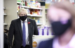 Britain's Prime Minister Boris Johnson visits a COVID-19 vaccination centre in a pharmacy in Sidcup, south east England, Friday Nov. 12, 2021, during a visit to Old Bexley and Sidcup.