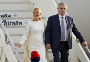 Argentina's President Alberto Fernandez, right, and his partner Fabiola Yanez disembark as they arrives at Rome's Fiumicino Airport, Friday, Oct. 29, 2021.