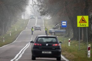 Polish police officers check cars near the border to Belarus