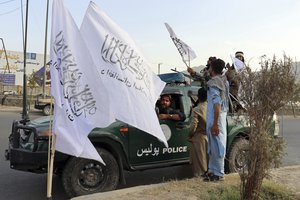 Taliban fighters buy Taliban flags in Kabul, Afghanistan, Monday, Aug. 30, 2021.