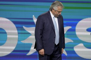 Argentine President Alberto Fernandez stands before supporters at the ruling party Front for Everyone campaign headquarters after polls closed for midterm legislative elections in Buenos Aires, Argentina, Sunday, Nov. 14, 2021