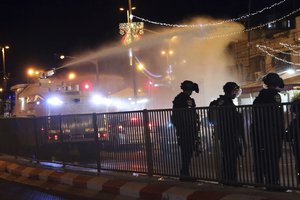 Israeli police use a water cannon to disperse Palestinian protesters from the area near the Damascus Gate to the Old City of Jerusalem after clashes at the Al-Aqsa Mosque compound, Friday, May 7, 2021.