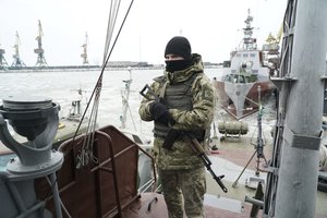 A Ukrainian serviceman stands on board a coast guard ship in the Sea of Azov port of Mariupol, eastern Ukraine, Monday, Dec. 3, 2018