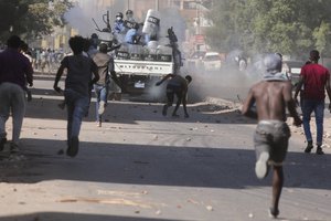 Sudanese confront the police during a protest against the military coup that ousted government last month, in Khartoum, Sudan, Wednesday, Nov. 17, 2021