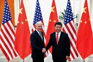 FILE PHOTO: Chinese President Xi Jinping shakes hands with U.S. Vice President Joe Biden (L) inside the Great Hall of the People in Beijing December 4, 2013