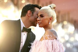 Actress and singer Lady Gaga, right, and actor Bradley Cooper pose for photographers upon arrival at the premiere of the film 'A Star Is Born' at the 75th edition of the Venice Film Festival in Venice, Italy, Friday, Aug. 31, 2018