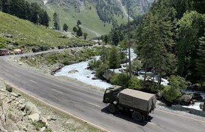 An Indian army convoy moves on the Srinagar- Ladakh highway at Gagangeer, north-east of Srinagar, Indian controlled Kashmir, Thursday, June 18, 2020. Indian security forces said neither side fired any shots in the clash in the Ladakh region late Monday that was the first deadly confrontation on the disputed border between India and China since 1975. China said Wednesday that it is seeking a peaceful resolution to its Himalayan border dispute with India following the death of 20 Indian soldiers in the most violent confrontation in decades. (AP Photo/STR)