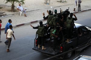 A Palestinian member of the 'Ezz Al-Din Al Qassam' militia, the military wing of Hamas, holds his weapon during a protest organized by Palestinian members from Youth Salafists group against the Egyptian and Syria regimes in Rafah Refugee Camp, southern Gaza Strip, Thursday, Aug. 22, 2013. Syrian government forces pressed their offensive in eastern Damascus on Thursday, bombing rebel-held suburbs where the opposition said the regime had killed more than 100 people the day before in a chemical weapons attack. The government has denied allegations it used chemical weapons in artillery barrages on the area known as eastern Ghouta on Wednesday as "absolutely baseless. Photo by Ahmed Deeb / WN