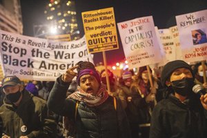 People march outside Barclay center, Wednesday, Nov. 17, 2021, in New York. Kyle Rittenhouse was acquitted of all charges Friday after pleading self-defense in the deadly Kenosha shootings that became a flashpoint in the debate over guns, vigilantism and racial injustice in the U.S.