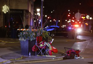 Toppled chairs are seen among holiday decorations in downtown Waukesha, Wis., after an SUV plowed into a Christmas parade injuring dozens of people Sunday, Nov 21. 2021.