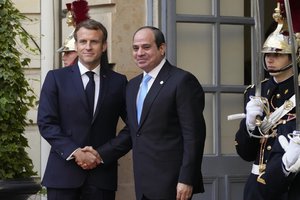 France's President Emmanuel Macron, left, greets Egyptian President Abdel-Fattah el-Sissi before a conference with several world leaders in Paris, Friday, Nov. 12, 2021.