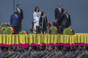 Ethiopia's Prime Minister Abiy Ahmed, right, First Lady Zinash Tayachew, center, and Djibouti's President Ismail Omar Guelleh, left, attend Abiy's inauguration ceremony after he was sworn in for a second five-year term, in the capital Addis Ababa, Ethiopia Monday, Oct. 4, 2021