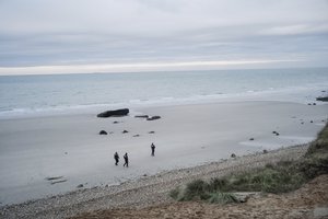 French police officers patrol on the beach in the searcher migrants in Wimereux, northern France, Wednesday, Nov.17, 2021