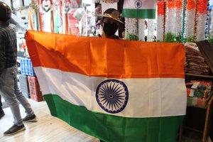 People buy items decorated in national flag colors at a market as the nation prepares to celebrate the Independence Day in Jammu,India, 14 August 2020.