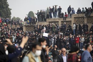 In this photo released by the semi-official Fars News Agency, farmers attend a protest demanding authorities open a dam to relieve drought-stricken areas of central province of Isfahan, on the dried up riverbed of the Zayandeh Roud river in the city of Isfahan 255 miles (410 kilometers) south of the capital Tehran, Iran, Friday, Nov. 19, 2021.