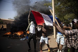 Protestors take to the streets of Burkina Faso's capital Ouagadougou Saturday Nov. 27, 2021, calling for President Roch Marc Christian Kabore to resign.