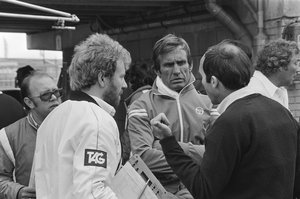 Team owner Frank Williams (right) talking to Williams-Ford Formula 1 driver Carlos Reutemann (center) during practice for the 1981 Zandvoort Formula 1 Grand Prix