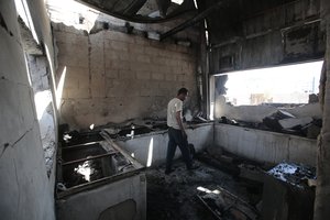 A worker inspects the damage to a plastic materials factory destroyed by Saudi-led airstrikes, in Sanaa, Yemen, Tuesday, Nov. 23, 2021