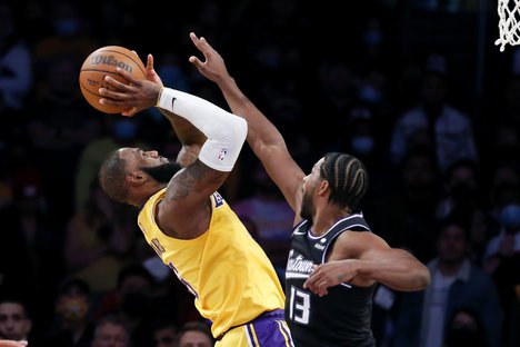 Los Angeles Lakers forward LeBron James, left, shoots against Sacramento Kings forward Tristan Thompson during the second half of an NBA basketball game in Los Angeles, Friday, Nov. 26, 2021. The Kings won 141-137 in triple overtime.