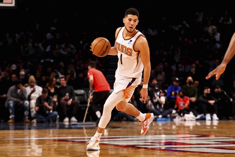 Phoenix Suns guard Devin Booker (1) carries the ball during the second half of an NBA basketball game, Saturday, Nov. 27, 2021, in New York.