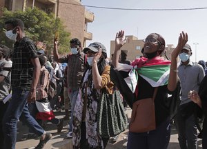 Sudanese calling for a civilian government march near the presidential palace in Khartoum, Sudan, Tuesday, Nov. 30, 2021.