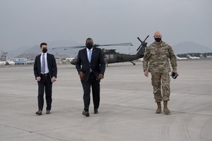 Secretary of Defense Lloyd J. Austin walks with the commander of Combined Security Transition Command – Afghanistan, Army Lt. Gen. E. John Deedrick Jr., before departing Kabul, Afghanistan, March 21, 2021