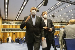 Mohammad Eslami, new head of Iran's nuclear agency (AEOI), left, and Iran's Governor to the International Atomic Energy Agency (IAEA), Kazem Gharib Abadi, left, leave the International Atomic Energy's (IAEA) General Conference in Vienna, Austria, Monday, Sept. 20, 2021