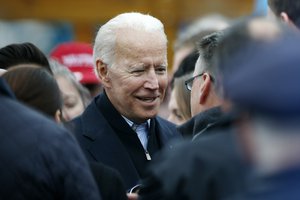 Former vice president Joe Biden talks with officials after speaking at a rally in support of striking Stop & Shop workers in Boston, Thursday, April 18, 2019.