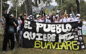 Ex-combatants of the disbanded FARC and social activists march to demand the government guarantee their right to life and compliance with the 2016 peace agreement, in Bogota, Colombia, Sunday, Nov. 1, 2020.