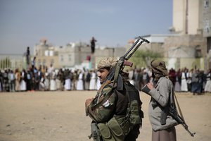 Armed Houthi fighters attend the funeral procession of Houthi rebel fighters who were killed in recent fighting with forces of Yemen's internationally recognized government, in Sanaa, Yemen, Wednesday, Nov. 24, 2021