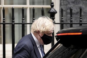 British Prime Minister Boris Johnson walks to get in a vehicle as he leaves 10 Downing Street to attend the weekly Prime Minister's Questions at the Houses of Parliament, in London, Wednesday, Dec. 8, 2021.