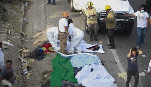 Bodies in bodybags are placed on the side of the road after an accident in Tuxtla Gutierrez, Chiapas state, Mexico, Thursday, Dec. 9, 2021.