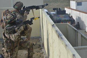 British soldiers of Bravo Company, 2nd Battalion, Royal Regiment of Fusiliers react to contact during a mission rehearsal exercise (MRE) at the Joint Multinational Readiness Center in Hohenfels, Germany