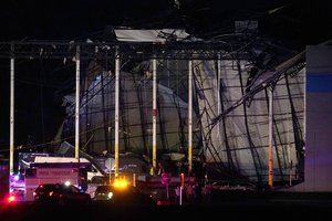 First responders work outside an Amazon fulfillment center after it was heavily damaged when a strong thunderstorm moved through the area Friday, Dec. 10, 2021, in Edwardsville