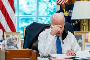 President Joe Biden reviews remarks he will deliver about the situation in Afghanistan, Thursday, August 19, 2021, in the Oval Office of the White House.