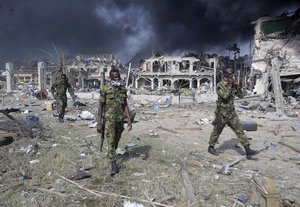 Soldiers walk near the site of an explosion in Lagos, Nigeria