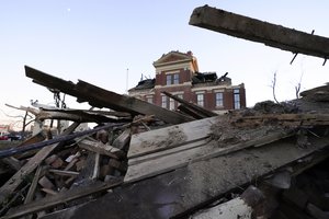 Debris is piled around the the damaged Graves County Courthouse Sunday, Dec. 12, 2021, in Mayfield, Ky. Tornadoes and severe weather caused catastrophic damage across several states Friday, killing multiple people.