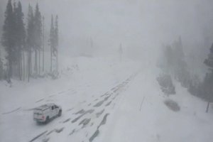 In this image taken from video from a Caltrans remote video traffic camera, a truck makes its way through the snow along Interstate 80 at Donner Summit, Calif., on Monday, Dec. 13, 2021.