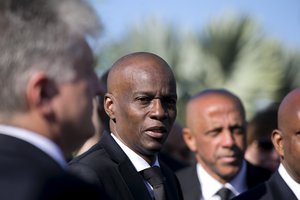 Haiti's President Jovenel Moise, center, attends a memorial service honoring the victims of the 2010 earthquake at Titanyen, a mass burial site north of Port-au-Prince, Haiti, Sunday, Jan. 12, 2020