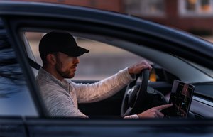 Man driving a Tesla car