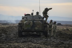 Russian servicemen take part in a military drills at Molkino training ground in the Krasnodar region, Russia, Tuesday, Dec. 14, 2021