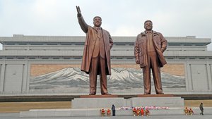 Soldiers pay respect to the bronze statues of their late leaders Kim Il Sung and Kim Jong Il