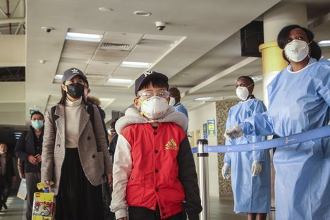 Passengers arriving from a China Southern Airlines flight from Changsha in China are screened for the new type of coronavirus, whose symptoms are similar to the cold or flu and many other illnesses, upon their arrival at the Jomo Kenyatta international airport in Nairobi, Kenya Wednesday, Jan. 29, 2020