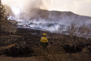 Ash and debris after an eruption of a volcano near El Paso on the island of La Palma in the Canaries, Spain, Tuesday, Sept. 21, 2021.